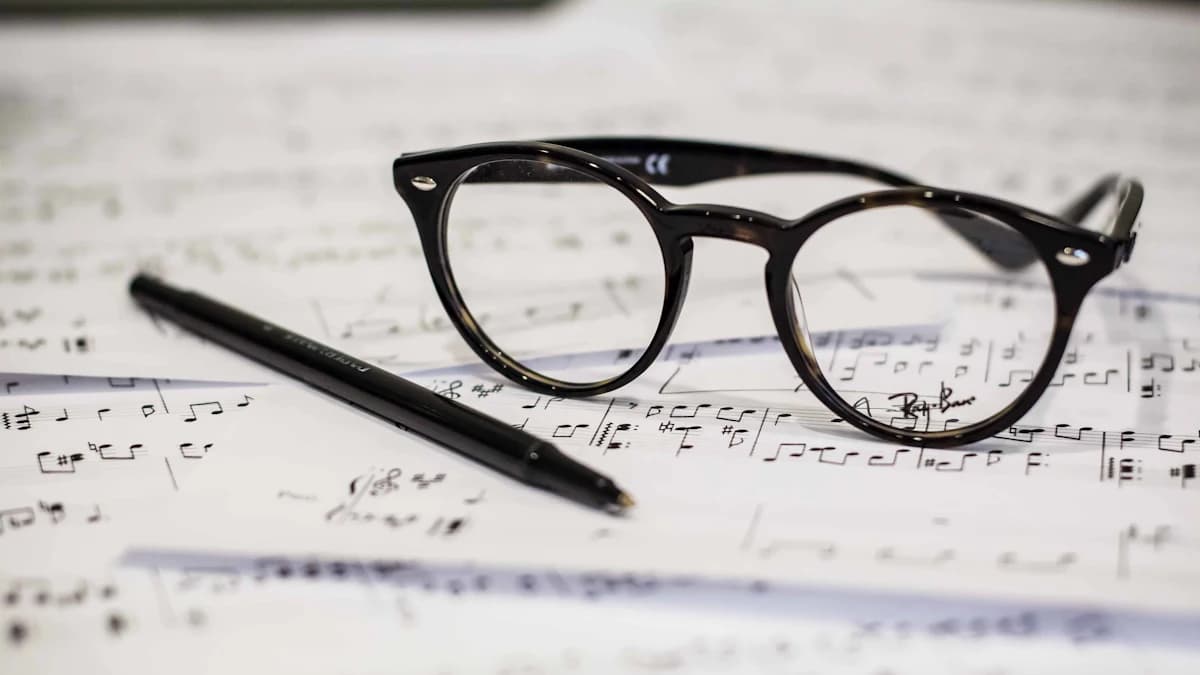 Glasses and a pen on a music score