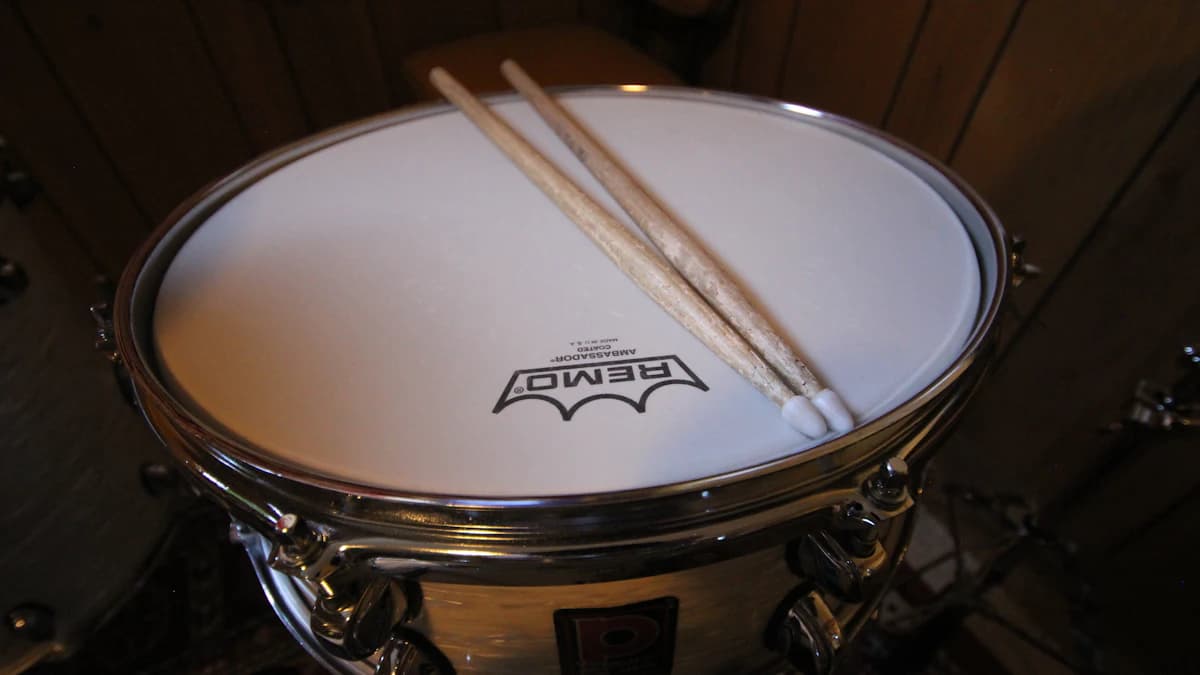 Drumsticks resting on a snare drum