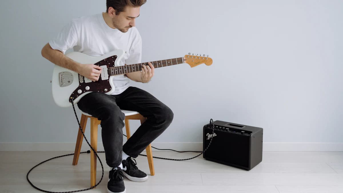 Guitarist practising electric guitar with an amp