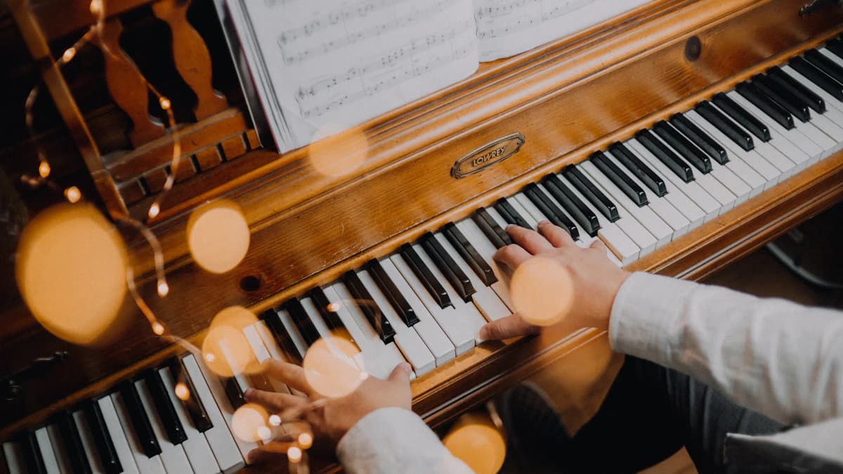 Hands playing piano from sheet music