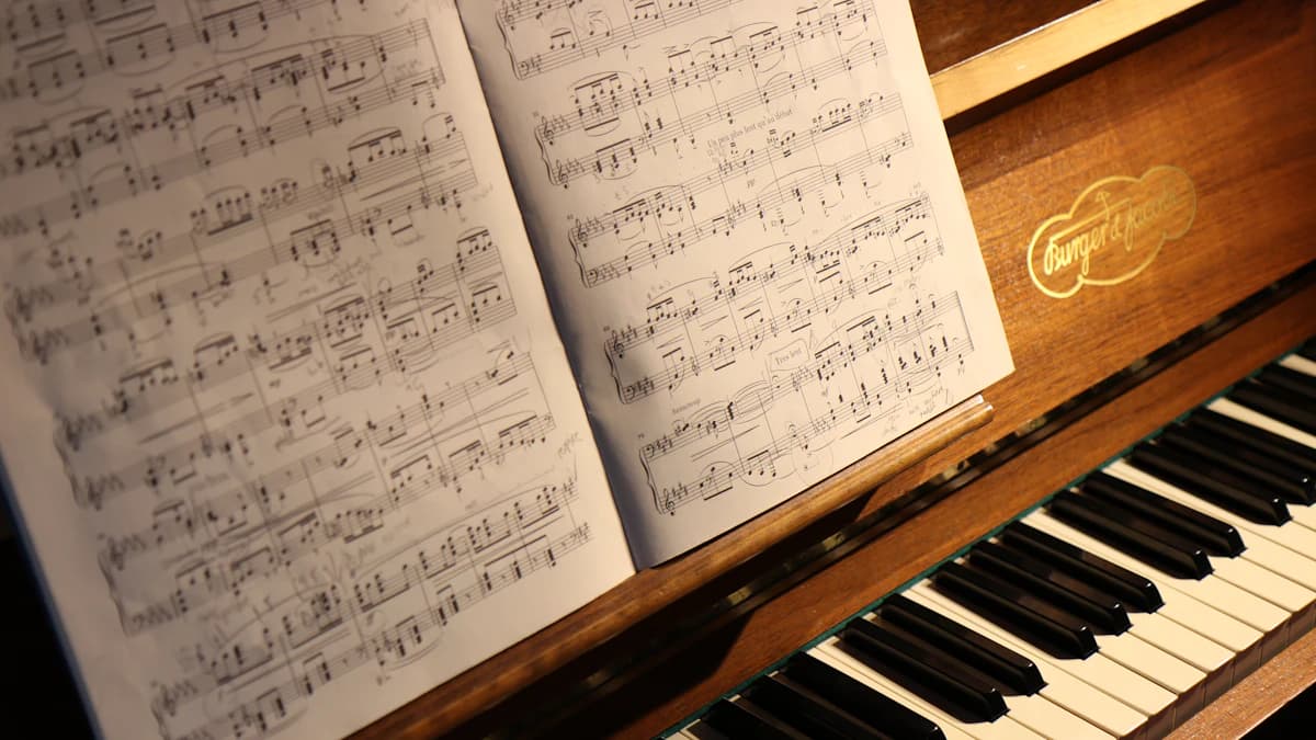 Songbook open on a piano
